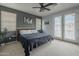 Comfortable main bedroom features a plush bed, ample natural light, and modern decor at 2367 W Dusty Wren Dr, Phoenix, AZ 85085