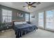 Comfortable main bedroom features a plush bed, ample natural light, and modern decor at 2367 W Dusty Wren Dr, Phoenix, AZ 85085