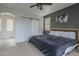 Spacious primary bedroom with carpet floor, sliding barn door, and stylish decor at 2367 W Dusty Wren Dr, Phoenix, AZ 85085