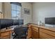 Well-lit office space featuring built-in desk and multiple monitors at 2367 W Dusty Wren Dr, Phoenix, AZ 85085