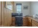 Cozy office space featuring wood paneling and built-in storage at 2367 W Dusty Wren Dr, Phoenix, AZ 85085