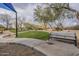 Community park featuring a walking path, bench seating, and desert landscaping with mature trees at 2367 W Dusty Wren Dr, Phoenix, AZ 85085