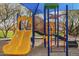Colorful playground with two slides, monkey bars, ladders, and climbing frame at 2367 W Dusty Wren Dr, Phoenix, AZ 85085