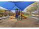 Community playground with shade covering, slides, and a soft wood-chip ground covering at 2367 W Dusty Wren Dr, Phoenix, AZ 85085
