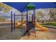 Community playground with blue awning, two slides, monkey bars, and climbing frame at 2367 W Dusty Wren Dr, Phoenix, AZ 85085