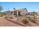 Expansive backyard featuring desert landscaping, a covered patio, and a sparkling pool, creating a serene retreat at 25043 S Hollygreen Dr, Sun Lakes, AZ 85248