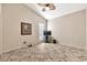 A simple bedroom features neutral paint, ceiling fan and tile flooring at 25043 S Hollygreen Dr, Sun Lakes, AZ 85248