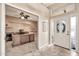 Inviting entryway features a decorative front door, neutral tile flooring, and an open view into the home office at 25043 S Hollygreen Dr, Sun Lakes, AZ 85248