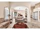 Comfortable living room with tile flooring, neutral tones, archways, and stylish decor at 25043 S Hollygreen Dr, Sun Lakes, AZ 85248