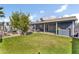 Spacious backyard featuring green lawn, covered patio, outdoor dining area, and pool at 2505 E Hampton Ave, Mesa, AZ 85204