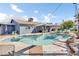 Backyard featuring a sparkling pool, lush lawn, covered patio, and outdoor seating at 2505 E Hampton Ave, Mesa, AZ 85204
