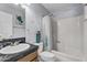 Bathroom with a shower and tub combination, vanity with black countertop, and decorative accents at 2505 E Hampton Ave, Mesa, AZ 85204