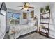 Cozy bedroom with a comfortable bed, ceiling fan, and views of the outdoors at 2505 E Hampton Ave, Mesa, AZ 85204