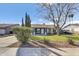 Inviting home with a well-kept lawn, mature landscaping, and an attached garage at 2505 E Hampton Ave, Mesa, AZ 85204