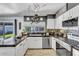 Modern kitchen featuring granite countertops, white cabinetry, and stainless steel appliances at 2505 E Hampton Ave, Mesa, AZ 85204