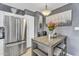 Eat-in kitchen with stainless steel fridge and a stylish table with seating at 2505 E Hampton Ave, Mesa, AZ 85204