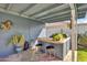 Outdoor kitchen featuring a built-in grill, bar seating, and a cozy covered area at 2505 E Hampton Ave, Mesa, AZ 85204