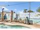 Sparkling pool with lounge chairs and tiki accents, surrounded by a colorful mural at 2505 E Hampton Ave, Mesa, AZ 85204
