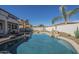 A stunning backyard with a sparkling pool, rock waterfall, and beautifully landscaped yard at 2506 E Bridgeport Pkwy, Gilbert, AZ 85295