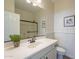 Bathroom featuring a framed mirror, white wainscotting, and walk-in shower with glass door at 2506 E Bridgeport Pkwy, Gilbert, AZ 85295
