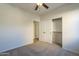Bright bedroom featuring a ceiling fan, carpeted floors, and sliding closet doors at 2506 E Bridgeport Pkwy, Gilbert, AZ 85295
