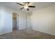 Carpeted bedroom features a ceiling fan and direct access to both the closet and hall at 2506 E Bridgeport Pkwy, Gilbert, AZ 85295