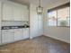 Bright dining area featuring granite counters, white cabinets, and natural light from the windows at 2506 E Bridgeport Pkwy, Gilbert, AZ 85295