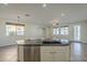 View of kitchen island leading into the living room with plenty of natural light and an open floor plan at 2506 E Bridgeport Pkwy, Gilbert, AZ 85295