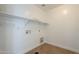 Functional laundry room with tile flooring, shelving, and utility connections for washer and dryer at 2506 E Bridgeport Pkwy, Gilbert, AZ 85295