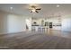 Large open-concept living area featuring a kitchen, island with seating, and a cozy carpeted area at 2506 E Bridgeport Pkwy, Gilbert, AZ 85295