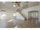 Spacious living room featuring a high ceiling, chandelier, and access to the second floor at 2506 E Bridgeport Pkwy, Gilbert, AZ 85295