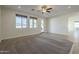 Bright and airy living room featuring neutral tones, carpet, and plenty of natural light at 2506 E Bridgeport Pkwy, Gilbert, AZ 85295