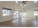 This spacious living room is enhanced by soaring ceilings, a chandelier and an abundance of natural light at 2506 E Bridgeport Pkwy, Gilbert, AZ 85295