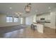 Spacious living room with large windows and an open plan layout to the kitchen at 2506 E Bridgeport Pkwy, Gilbert, AZ 85295