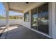 Covered patio with concrete flooring and view to the backyard through sliding glass doors and a large block wall at 2506 E Bridgeport Pkwy, Gilbert, AZ 85295