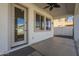 Covered patio with ceiling fan and neutral colors with convenient access door to the backyard at 2506 E Bridgeport Pkwy, Gilbert, AZ 85295