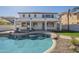 A view of the refreshing backyard pool complete with stone accents, lounge chairs and covered patio at 2506 E Bridgeport Pkwy, Gilbert, AZ 85295