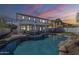 Backyard view of the pool with rock features, covered patio, and lush landscaping at 2506 E Bridgeport Pkwy, Gilbert, AZ 85295