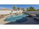 A private backyard oasis featuring a rock waterfall pool, palm trees, and lush landscaping at 2506 E Bridgeport Pkwy, Gilbert, AZ 85295