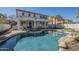 Enjoy this backyard pool with stone accents, lounge chairs and a covered patio, great for entertaining at 2506 E Bridgeport Pkwy, Gilbert, AZ 85295