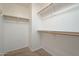 Walk-in closet with built-in shelving and hanging rods for efficient storage at 2506 E Bridgeport Pkwy, Gilbert, AZ 85295