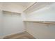 Walk-in closet with built-in shelving and hanging rods for efficient storage at 2506 E Bridgeport Pkwy, Gilbert, AZ 85295