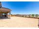 Large dirt backyard with fence line and covered patio at 25393 N 158Th Ct, Surprise, AZ 85387
