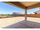 Covered patio overlooks a dirt backyard with views of the neighborhood at 25393 N 158Th Ct, Surprise, AZ 85387