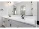 Bathroom vanity with double sinks, white cabinets and black hardware at 25393 N 158Th Ct, Surprise, AZ 85387