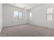 Spacious and bright bedroom with three windows and neutral carpet flooring at 25393 N 158Th Ct, Surprise, AZ 85387