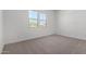 Bright bedroom with neutral carpet and a window overlooking the backyard at 25393 N 158Th Ct, Surprise, AZ 85387
