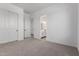 Bright bedroom features neutral carpet, closet doors, and ensuite bath access at 25393 N 158Th Ct, Surprise, AZ 85387