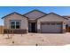 Charming single-story home with a well-manicured stone and stucco facade at 25393 N 158Th Ct, Surprise, AZ 85387