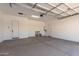 A spacious garage with white walls and concrete floor at 25393 N 158Th Ct, Surprise, AZ 85387
